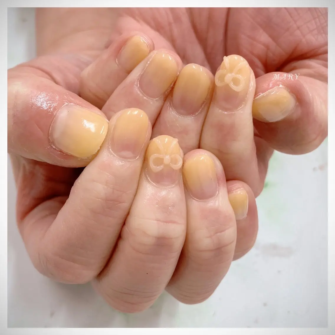 ネイル ニュアンスネイル リボン 春ネイル 黄色 Mary nail .narumiのネイルデザイン