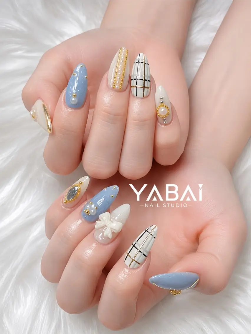 ネイル ブルー 長さ出し ゴールド ロングネイル リボン YABAI NailStudioのネイルデザイン
