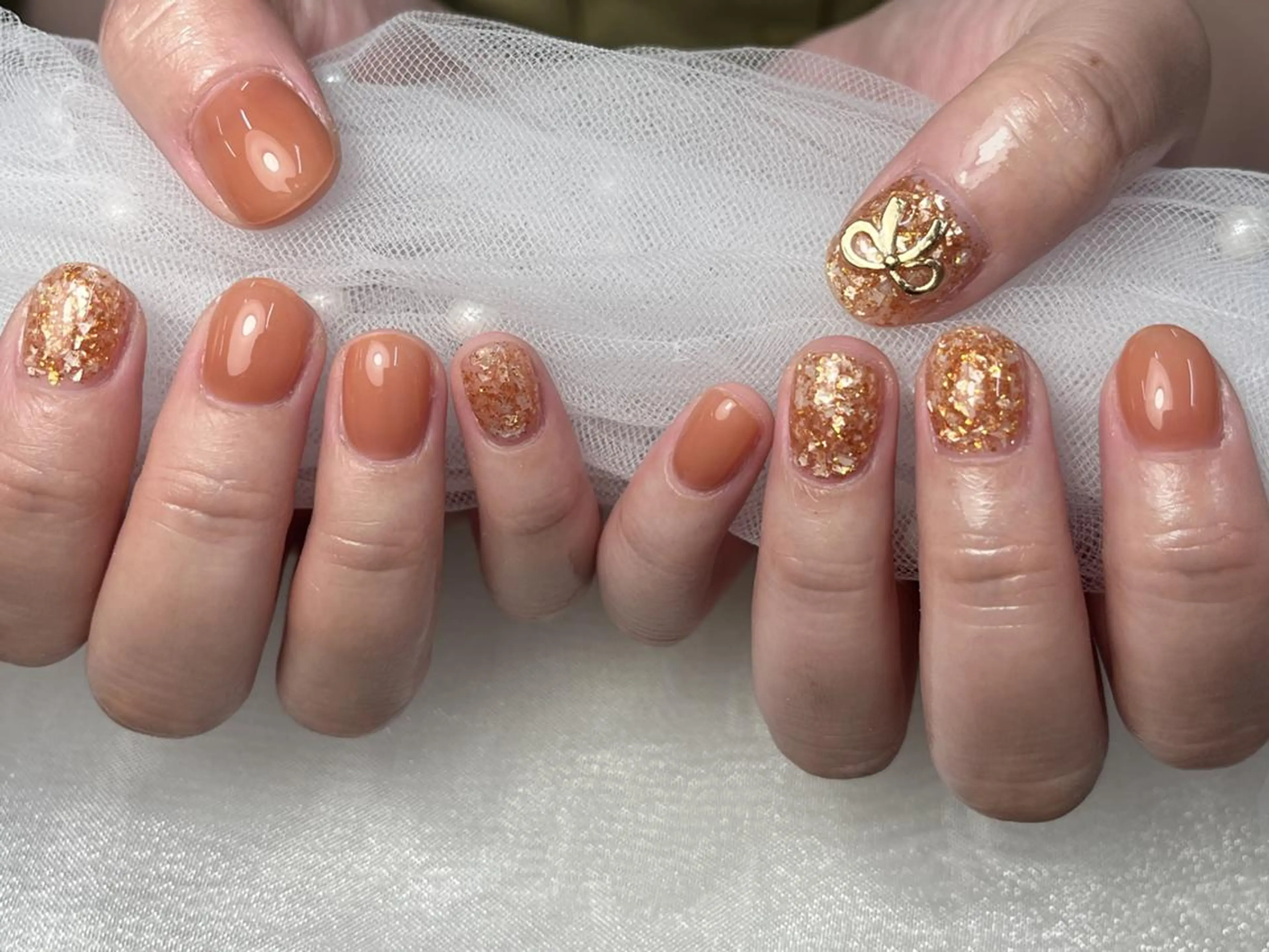 ネイル ゴールド ゴージャス キラキラネイル オレンジ リボン ハンドネイル ToliyDeliy Nail Salonのネイルデザイン
