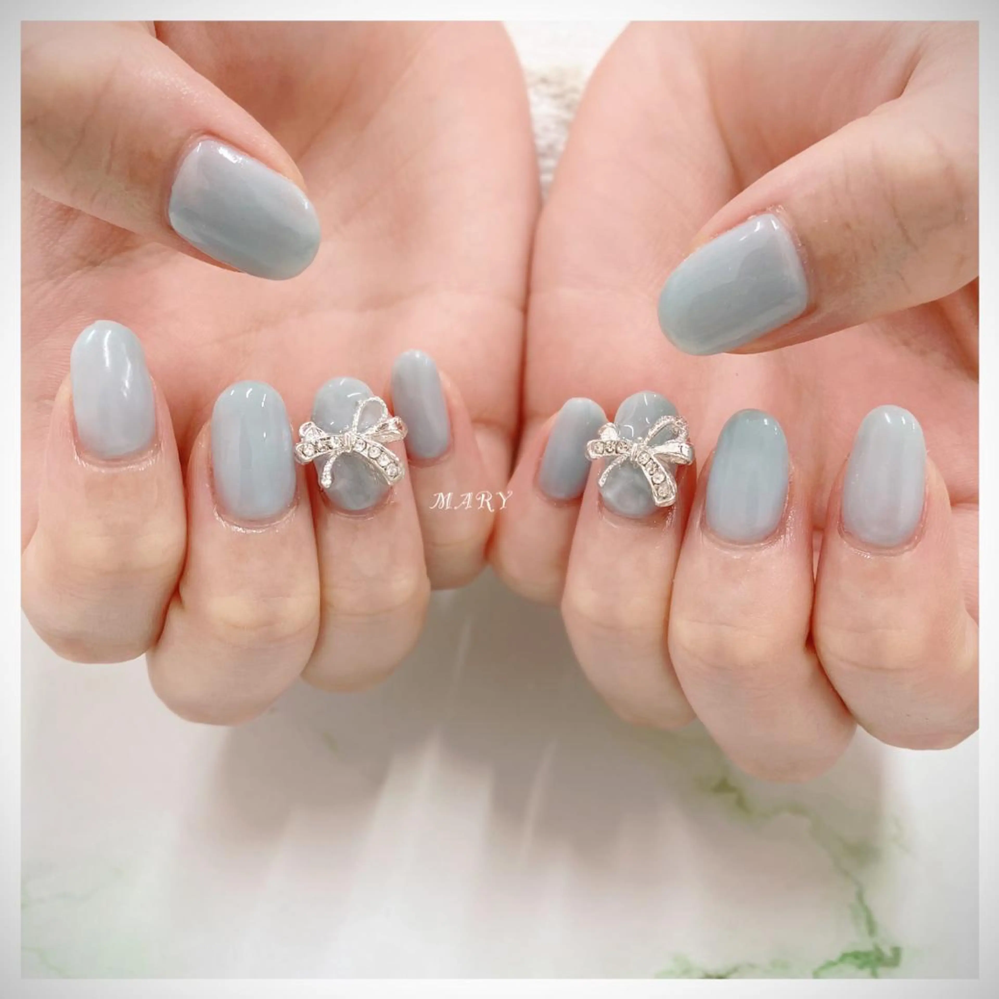ネイル 水色 ニュアンスネイル ワンカラーネイル リボン ハンドネイル Mary nail .narumiのネイルデザイン