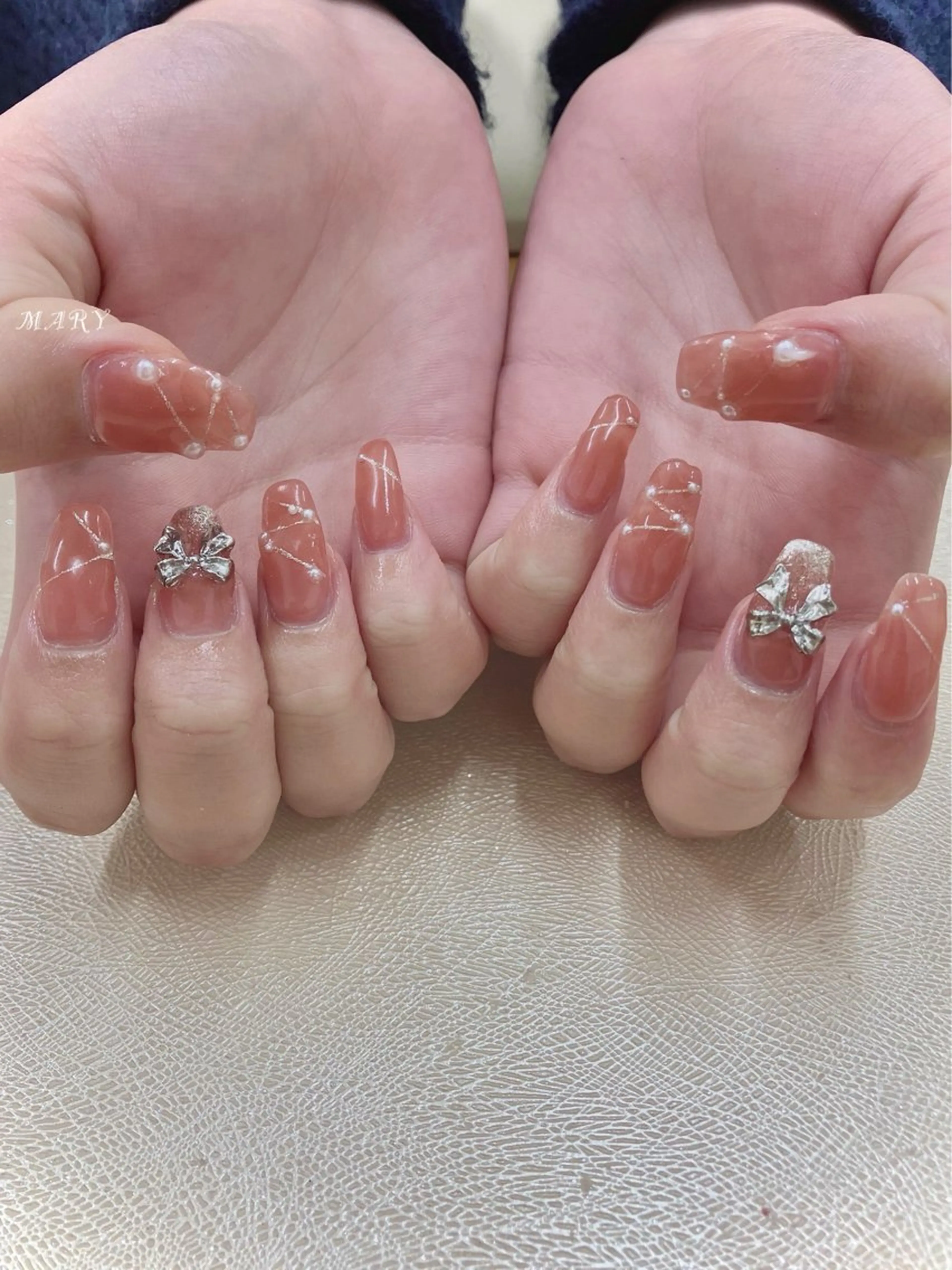 ネイル ニュアンスネイル ワンカラーネイル オレンジ ピンク リボン ハンドネイル Mary nail .narumiのネイルデザイン