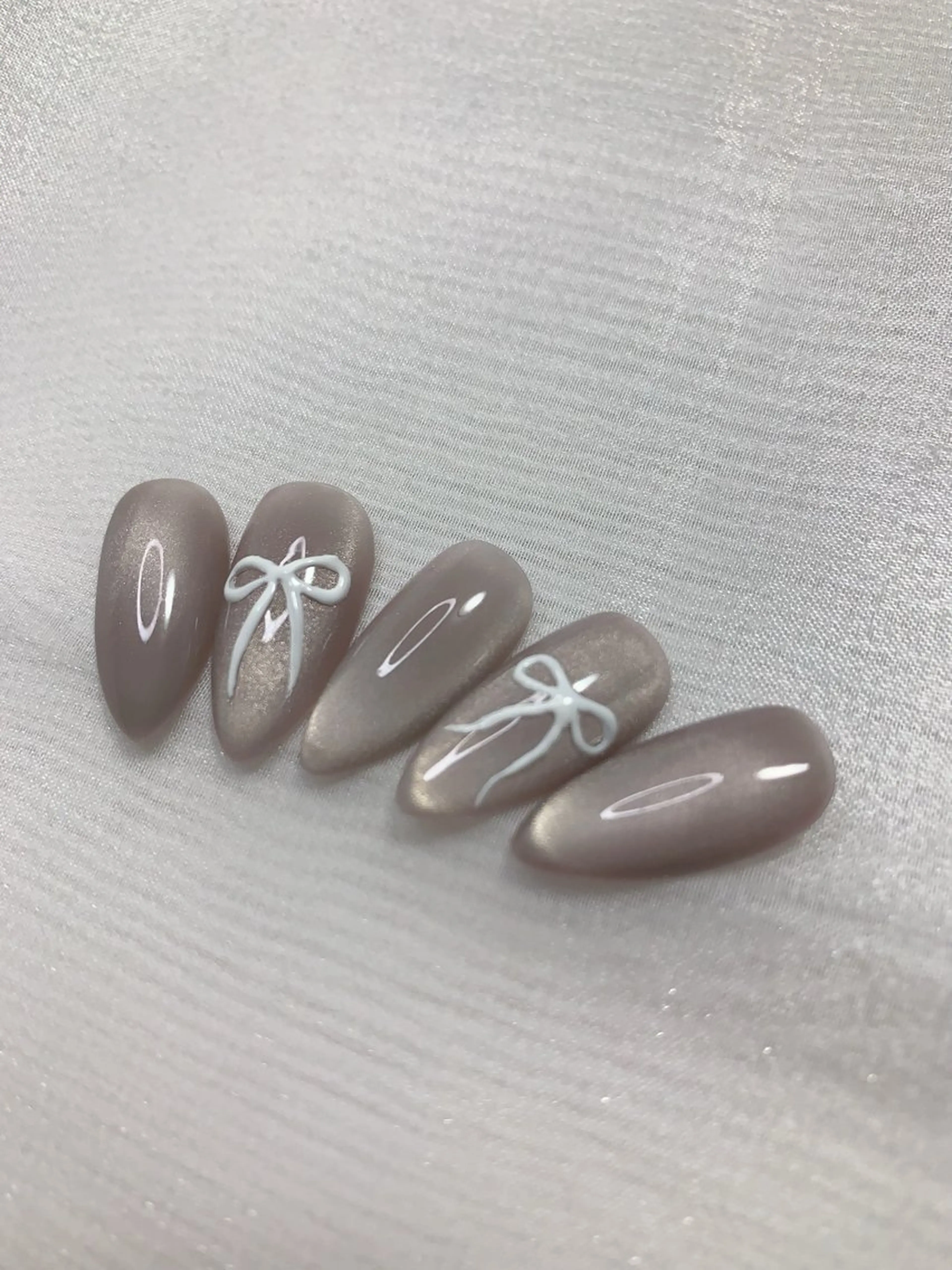 ネイル キラキラネイル マグネットネイル リボン Cute Tips nailのネイルデザイン