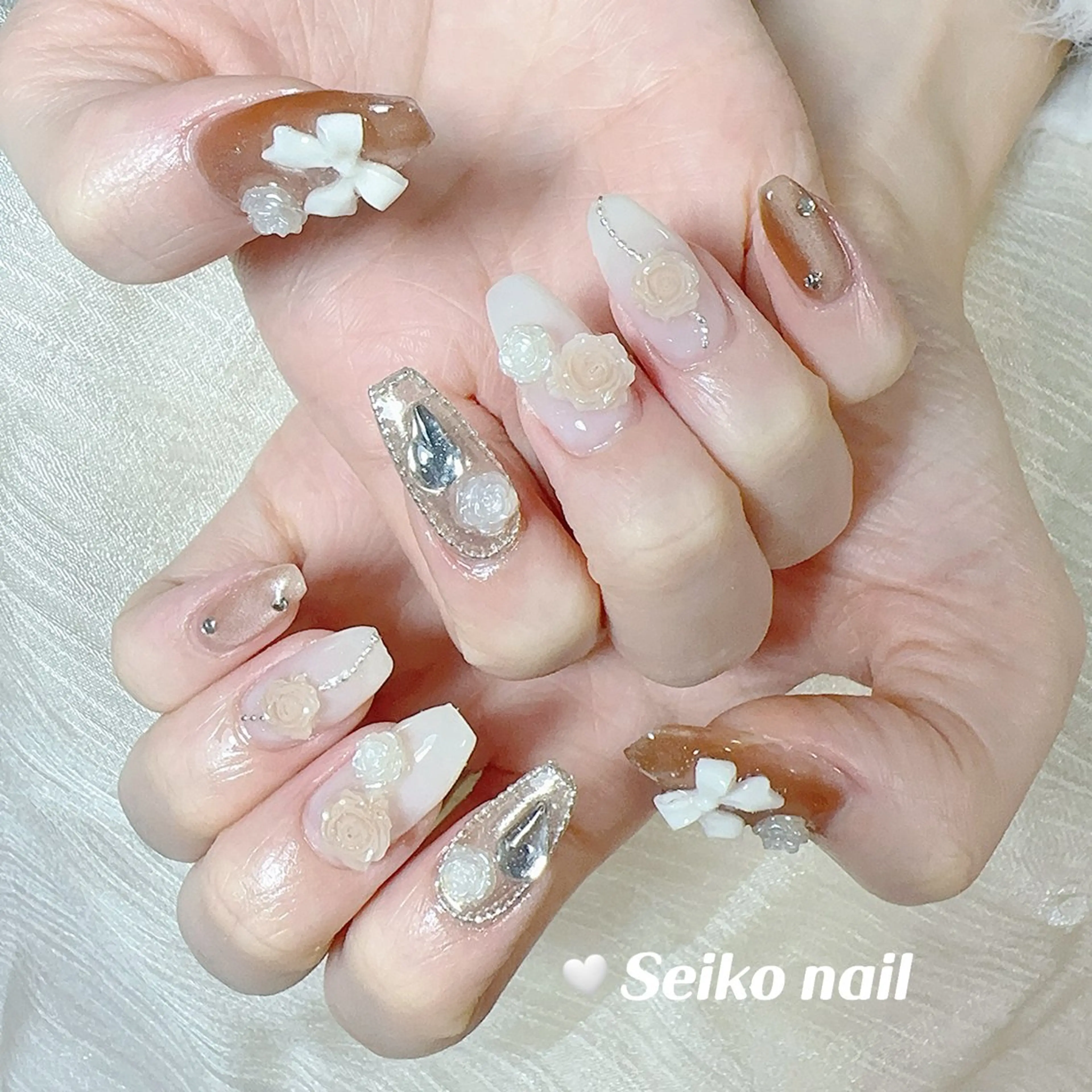 ネイル ガーリー キラキラネイル 韓国ネイル ピンク リボン ハンドネイル seiko nail Nanami（渋谷）のネイルデザイン