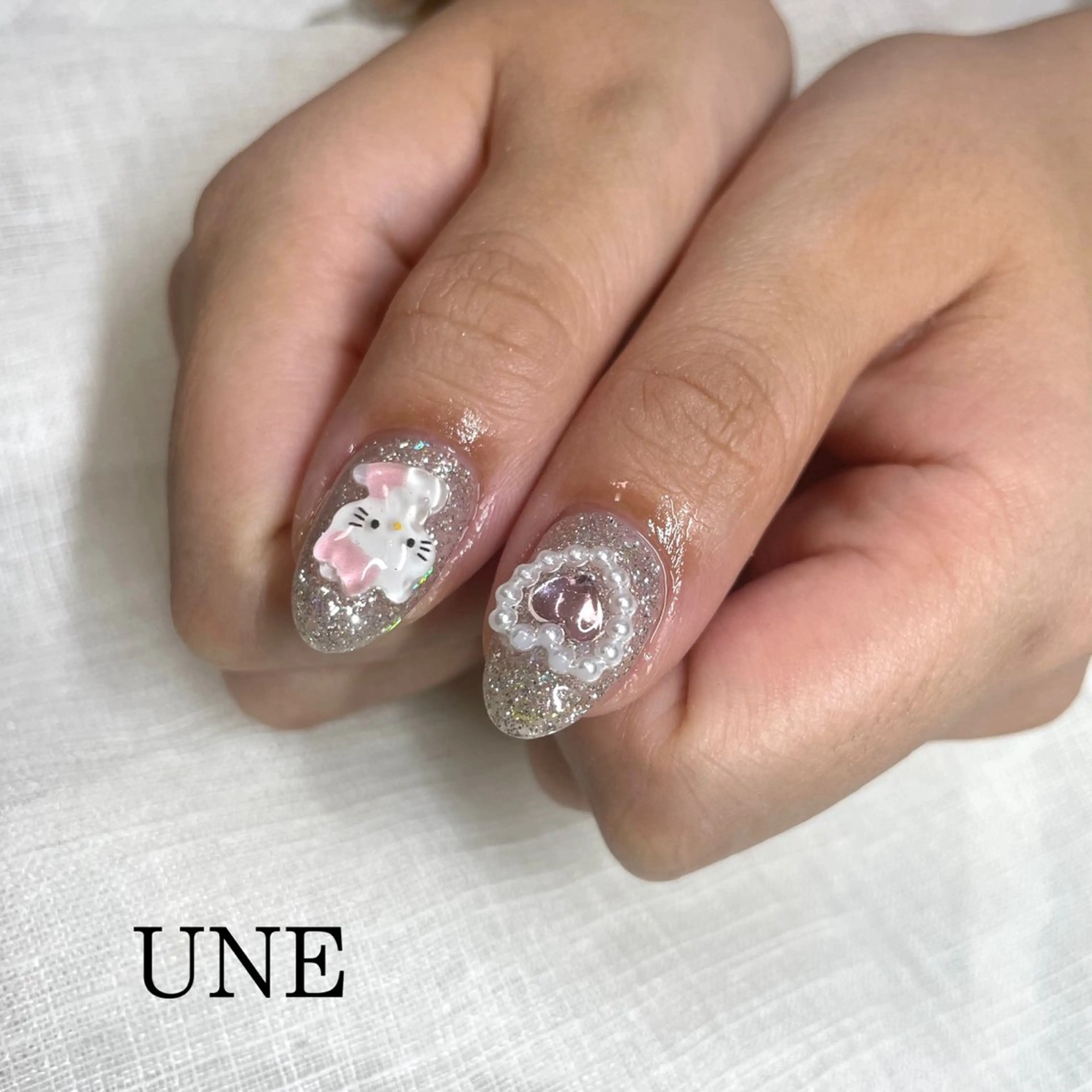 ネイル ハート キラキラネイル UNE.【ユヌ】 Jr.NANAのネイルデザイン