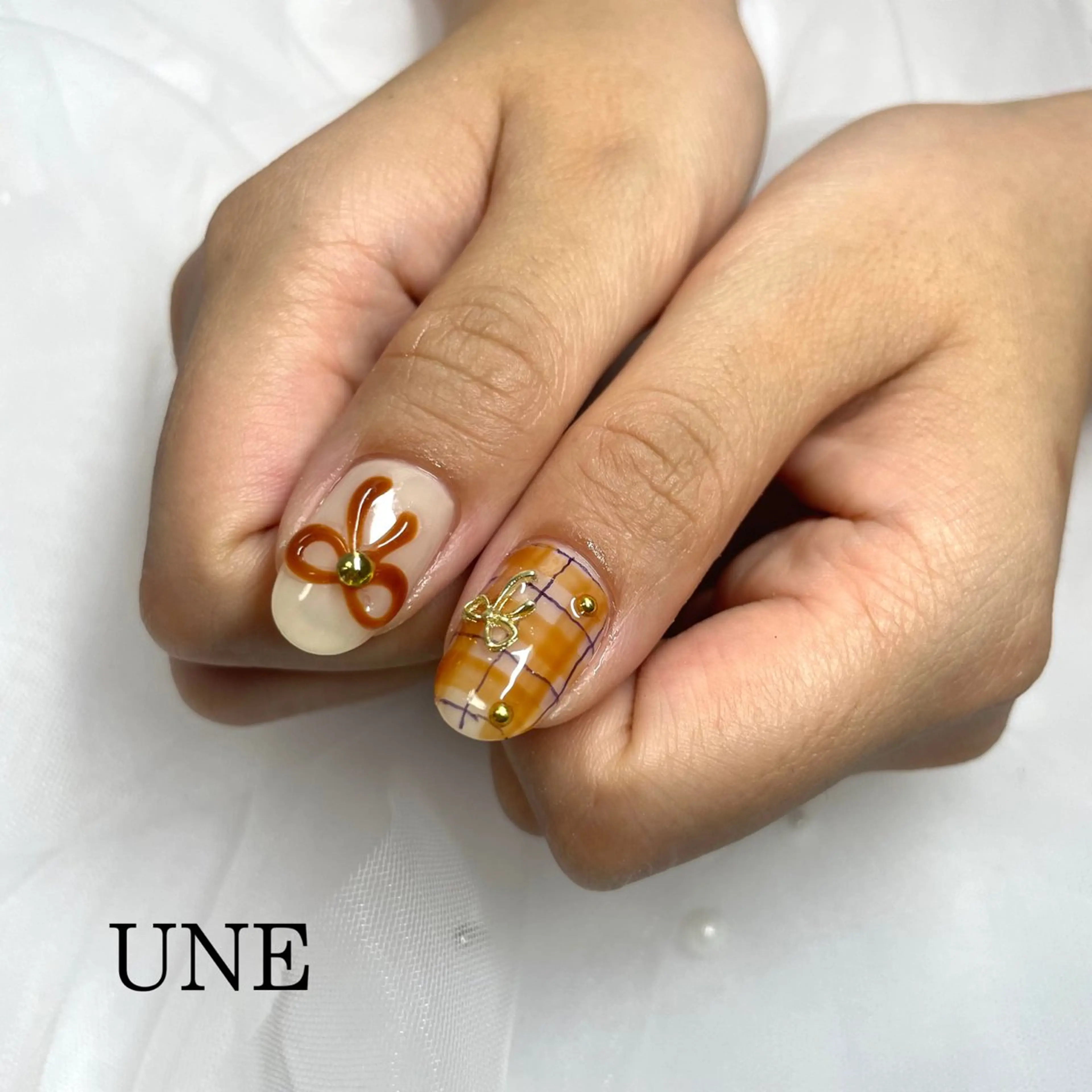 ネイル リボン UNE.【ユヌ】 Jr.NANAのネイルデザイン