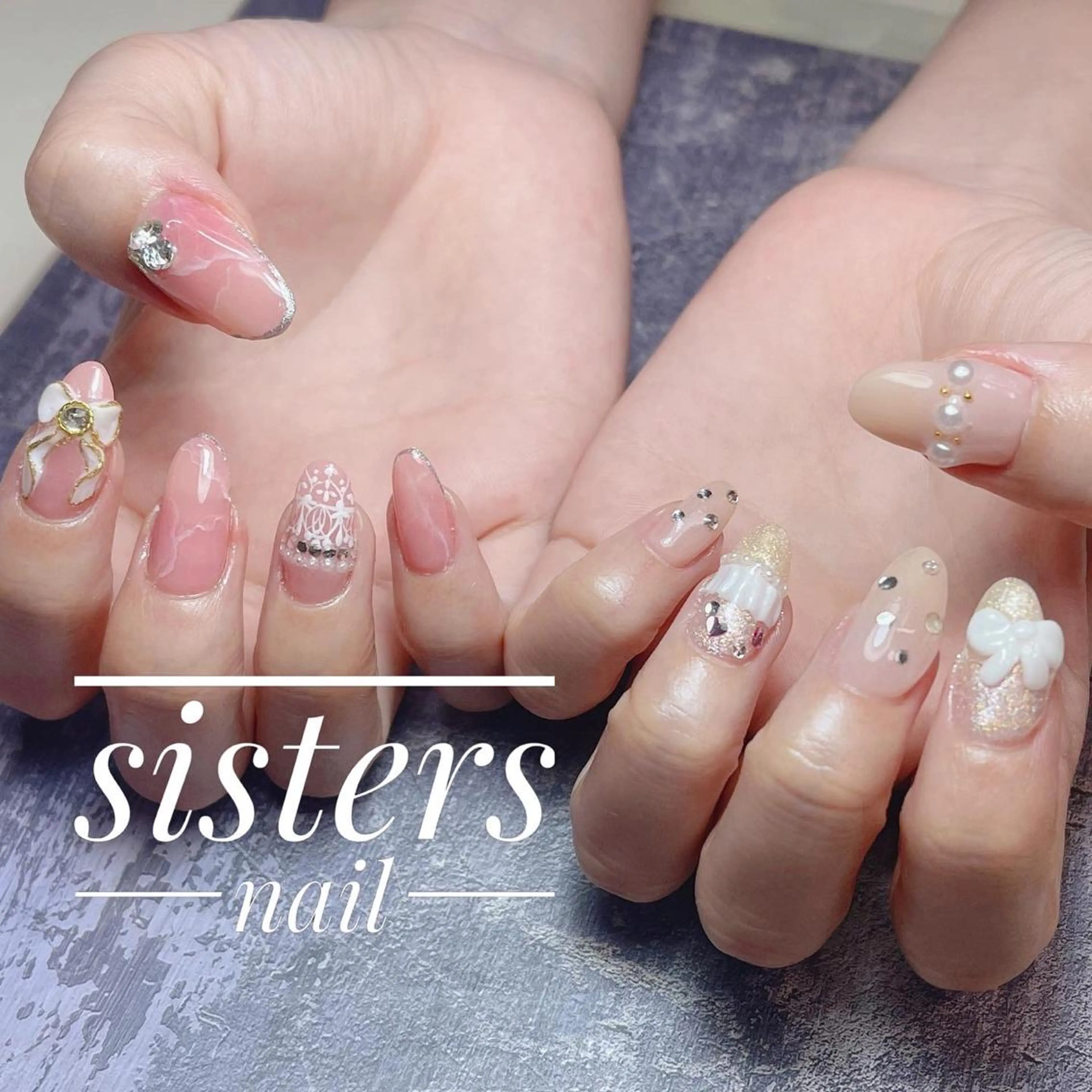 ネイル アートネイル キラキラネイル 大理石ネイル(マーブル) ピンク リボン ハンドネイル ハンドケア sisters nail.fのネイルデザイン
