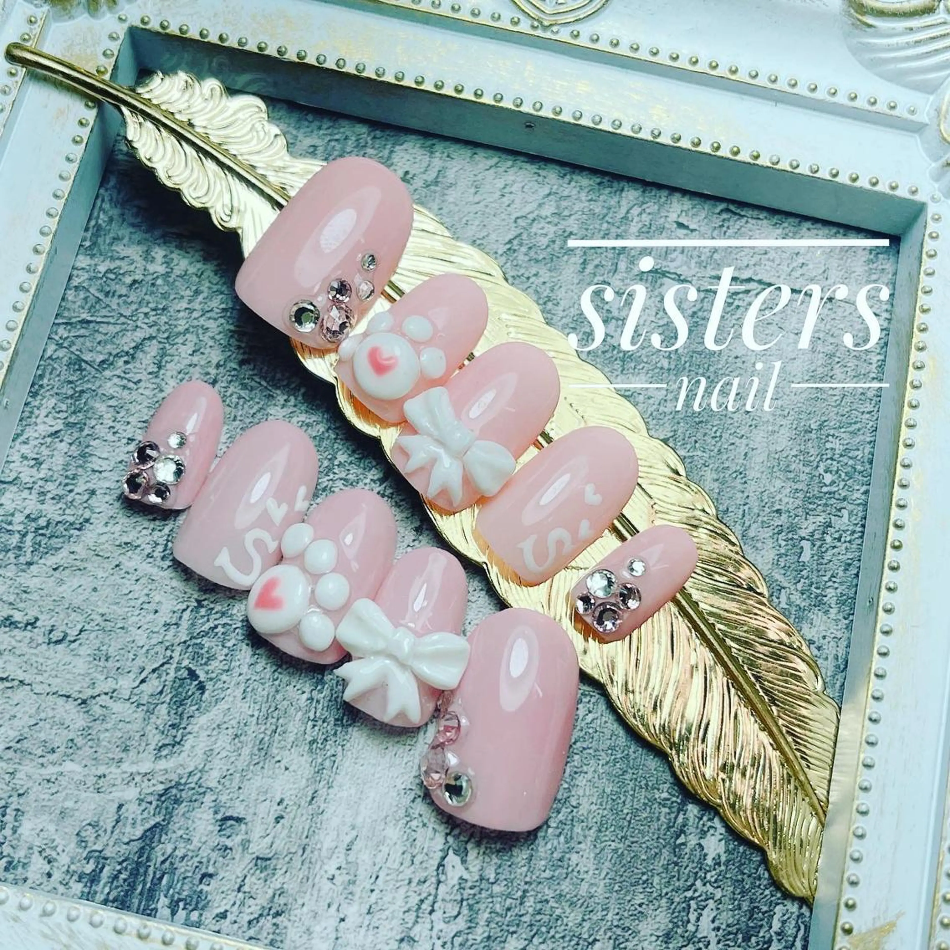 ネイル アートネイル ハート リボン ネイルチップ sisters nail.fのネイルデザイン