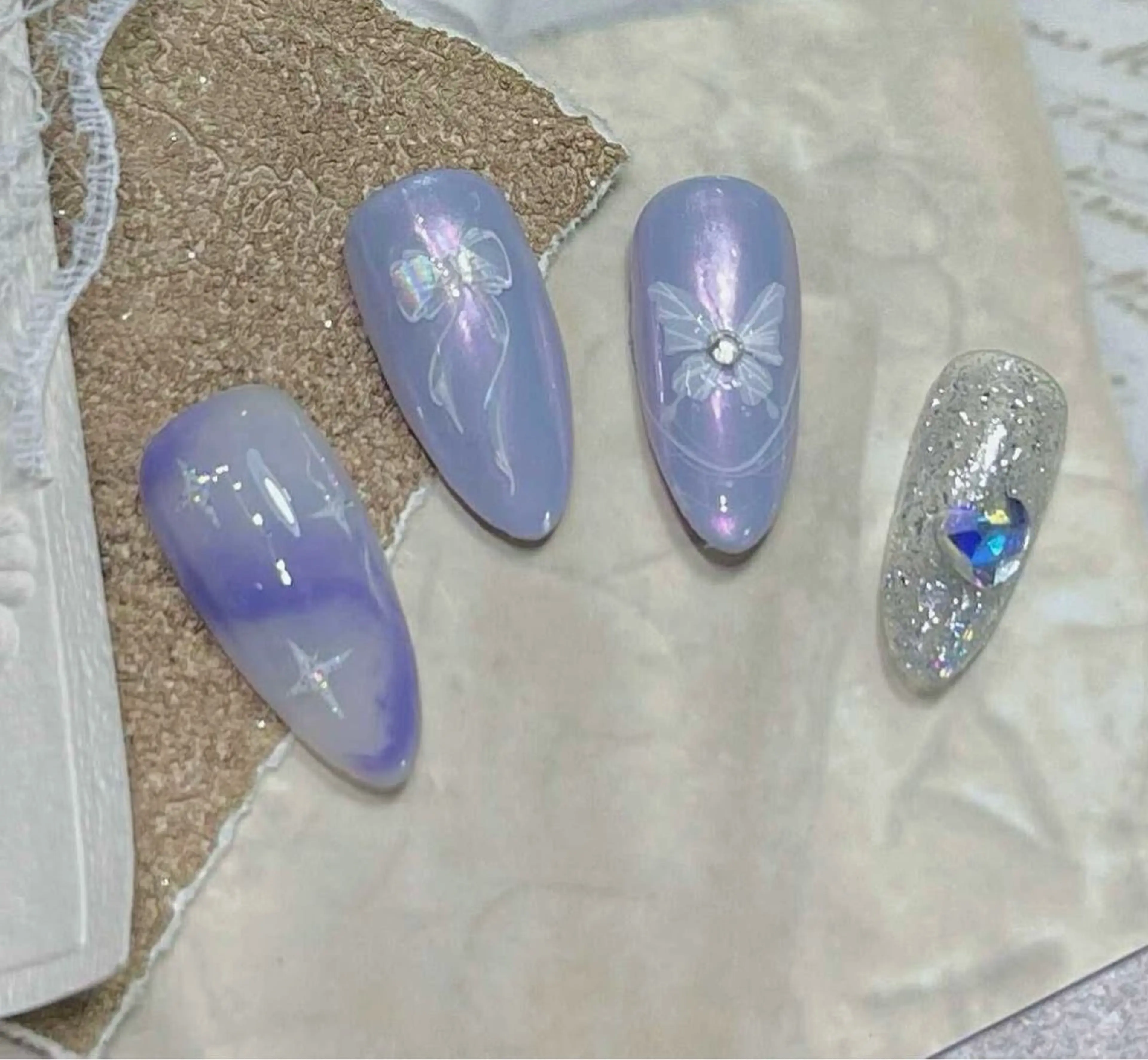 ネイル アートネイル パープル リボン ストーンネイル ハンドネイル ハンドケア ヒユ ビューティーのネイルデザイン