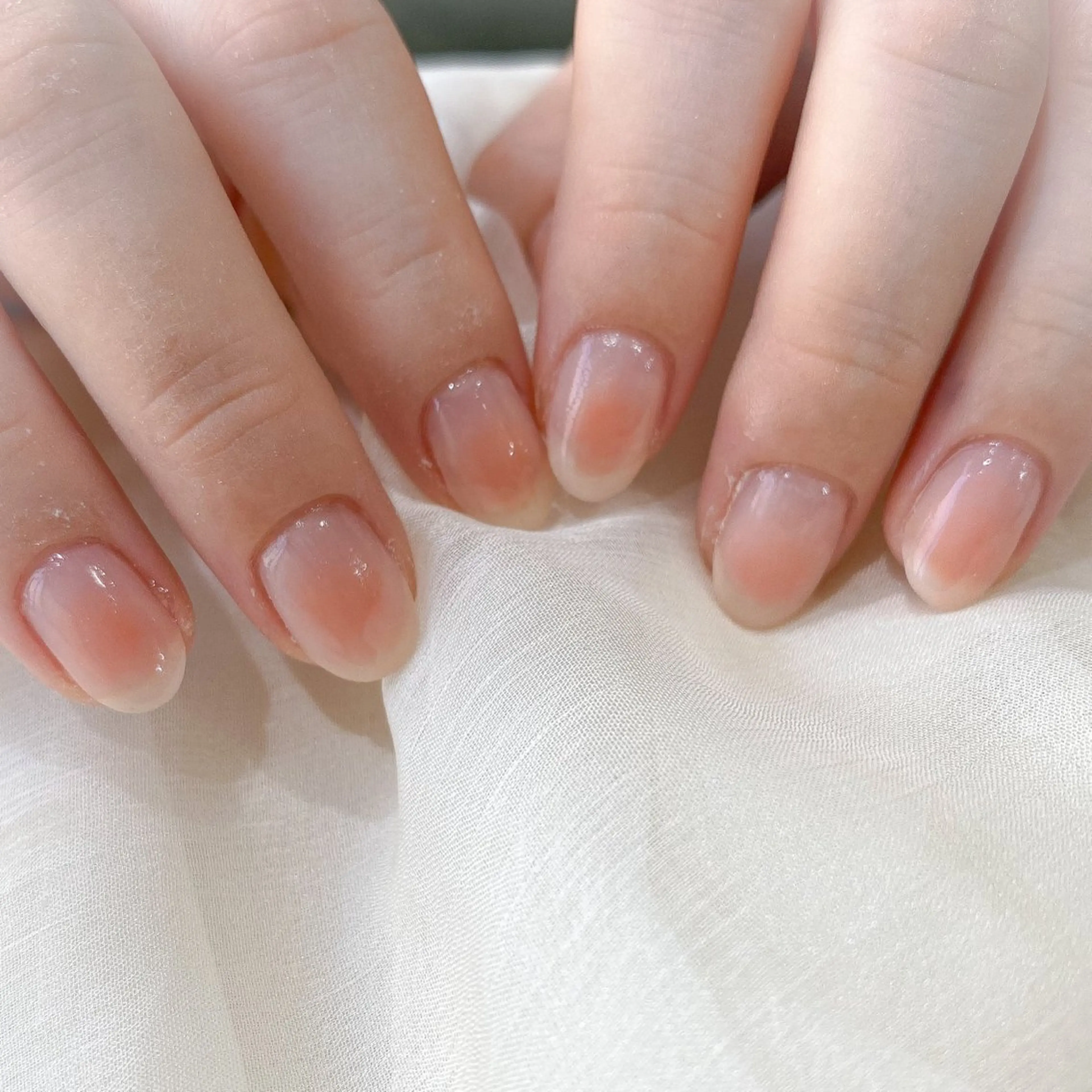 ネイル チークネイル オレンジ ピンク ネイル空間所属・muguet🎀 nailのネイルデザイン