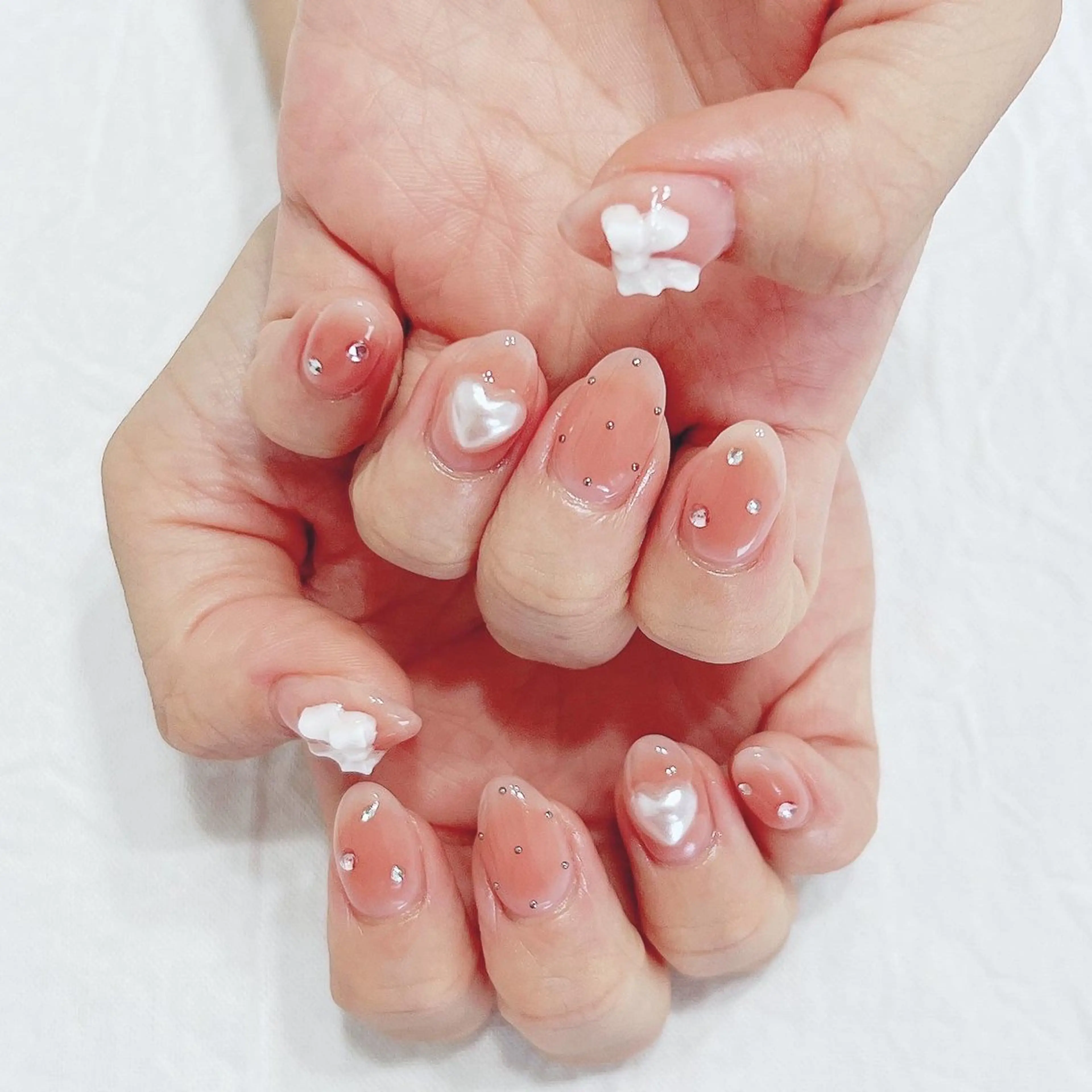 ネイル チークネイル ハート ピンク リボン ストーンネイル ハンドネイル peaberry nailのネイルデザイン
