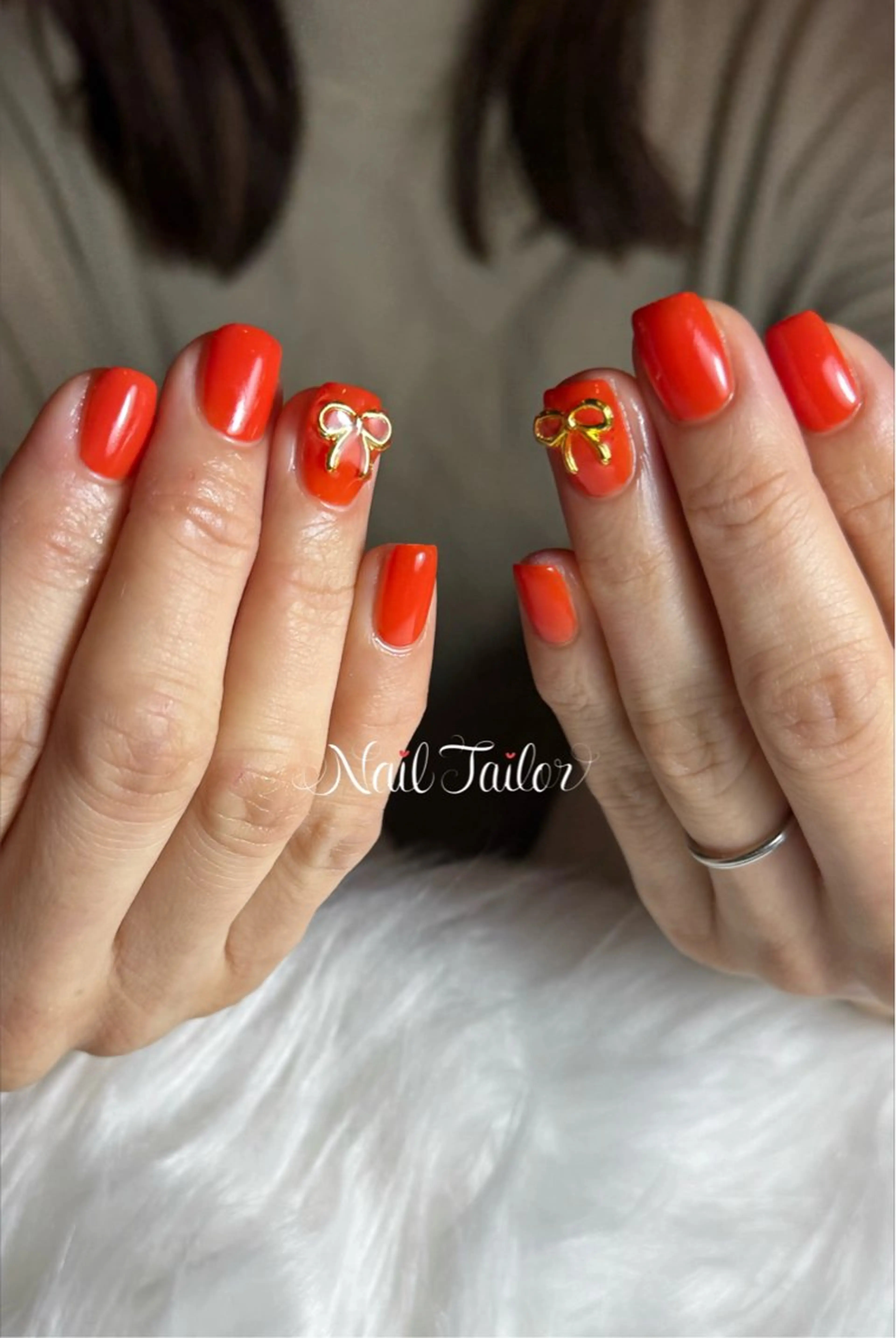 ネイル ワンカラーネイル オレンジ リボン ショートネイル スクエアネイル ハンドネイル 〜Nail Tailor〜　ネイルテイラー所属・NailTailor ネイルテイラーのネイルデザイン