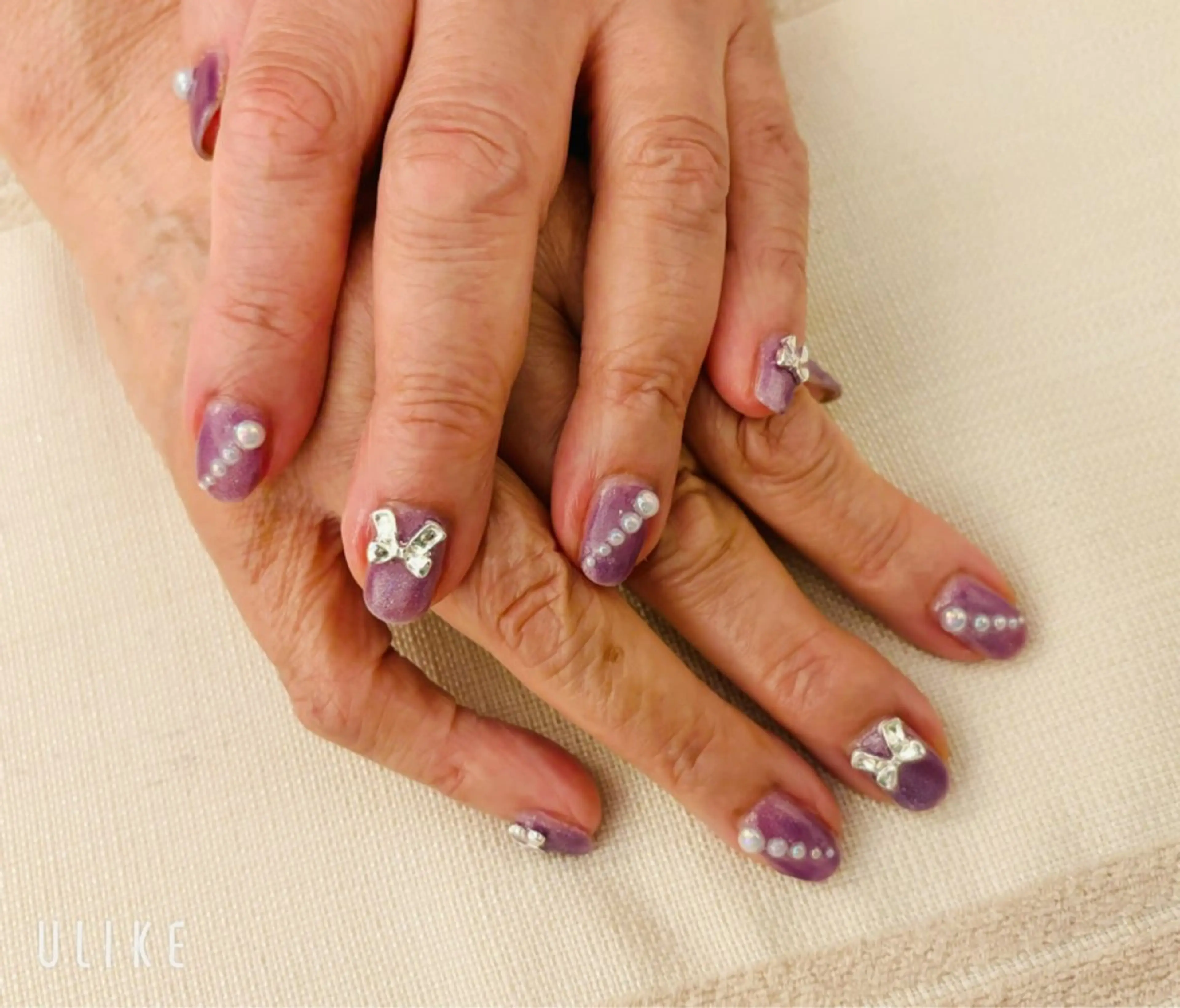 ネイル マグネットネイル ワンカラーネイル ピンク リボン ハンドネイル nail salon いづみ(節花内)所属・ネイルサロン いづみ(節花内)のネイルデザイン