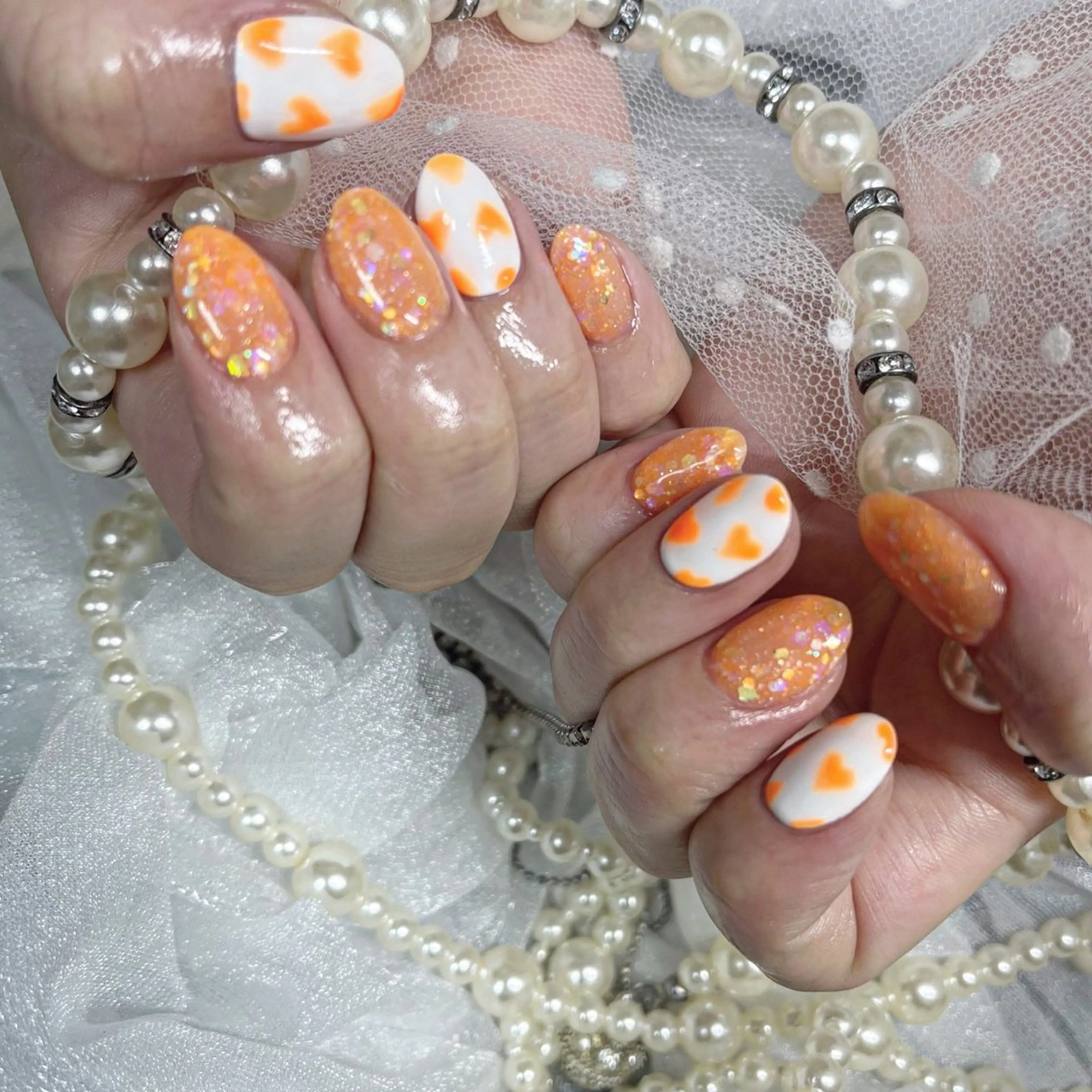 ネイル アートネイル ハート キラキラネイル ラメ(グリッター) オレンジ ハンドネイル フットネイル honu nailのネイルデザイン