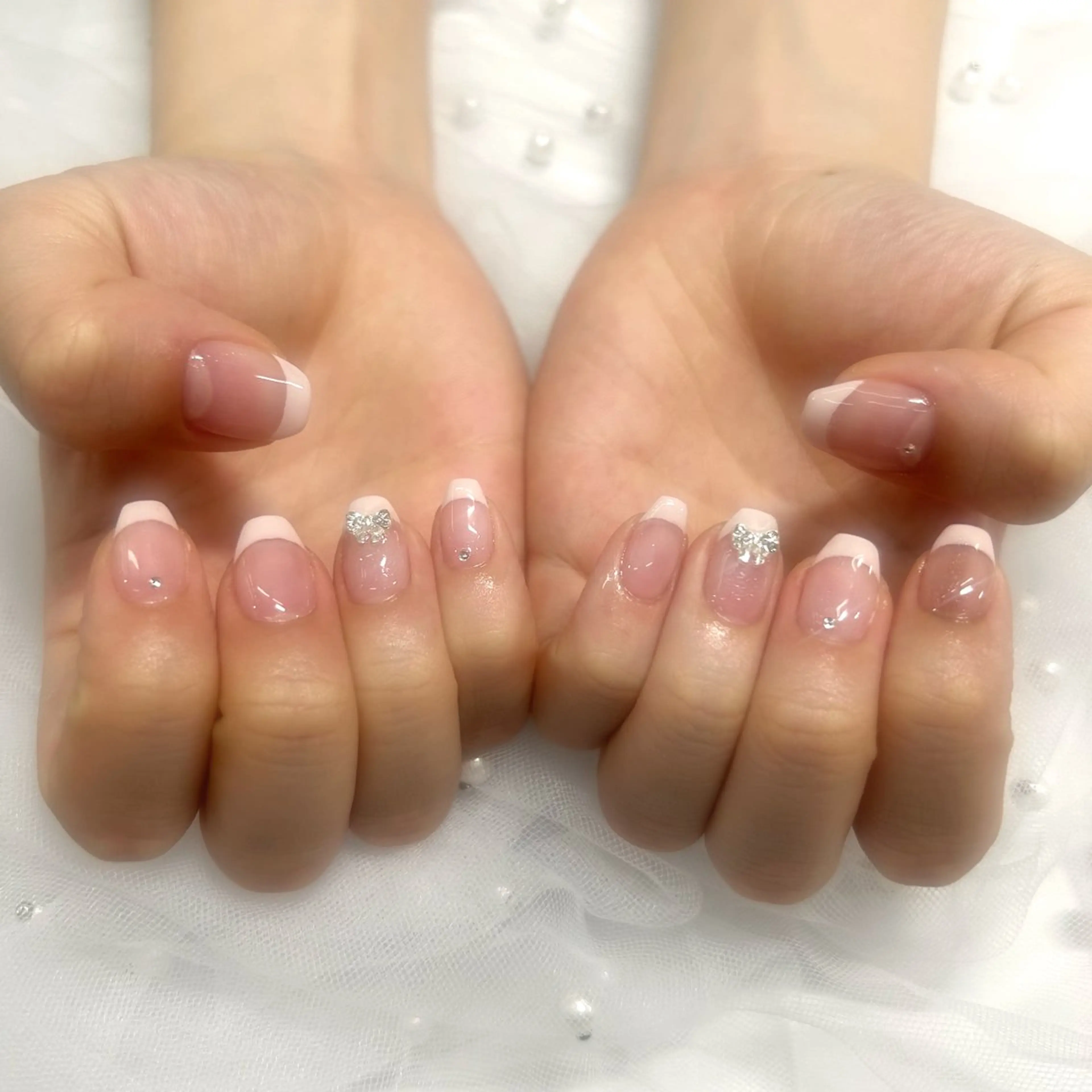 ネイル クリアネイル フレンチネイル ピンク リボン ストーンネイル ハンドネイル hinata池袋 🌙WOLTOKYOのネイルデザイン