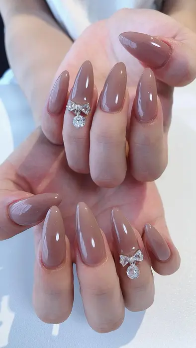 すくみピンクのワンカラーにリボンがおかわ Nail Salon Ef所属 M Tomoのネイルデザイン ミニモ